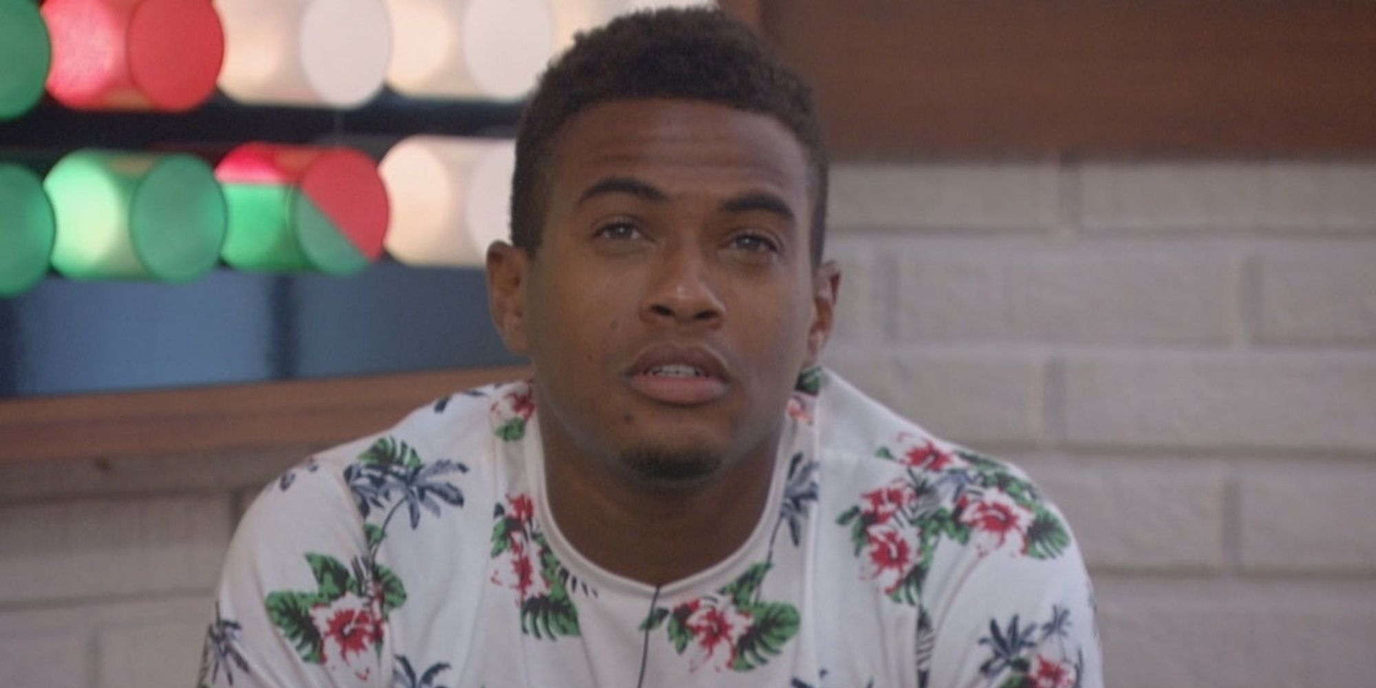 David from Big Brother All-Stars, wearing a floral shirt and looking up.