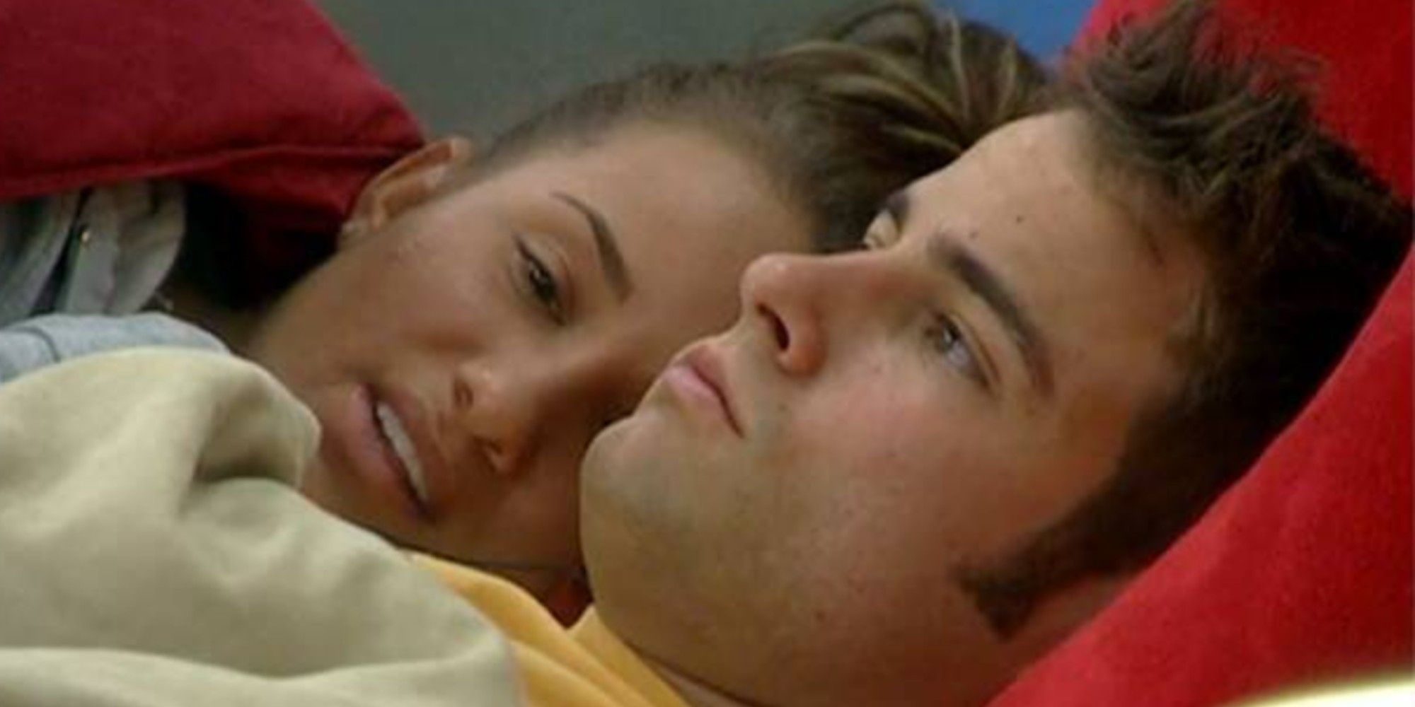 Two people cuddling in bed on Big Brother