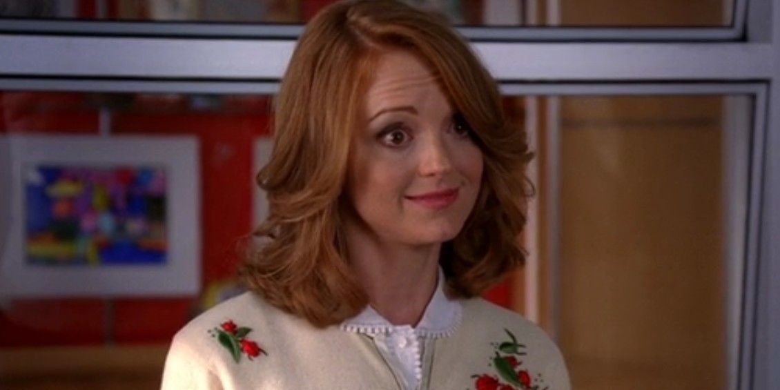 Emma Pillsbury smiling while at her office on Glee