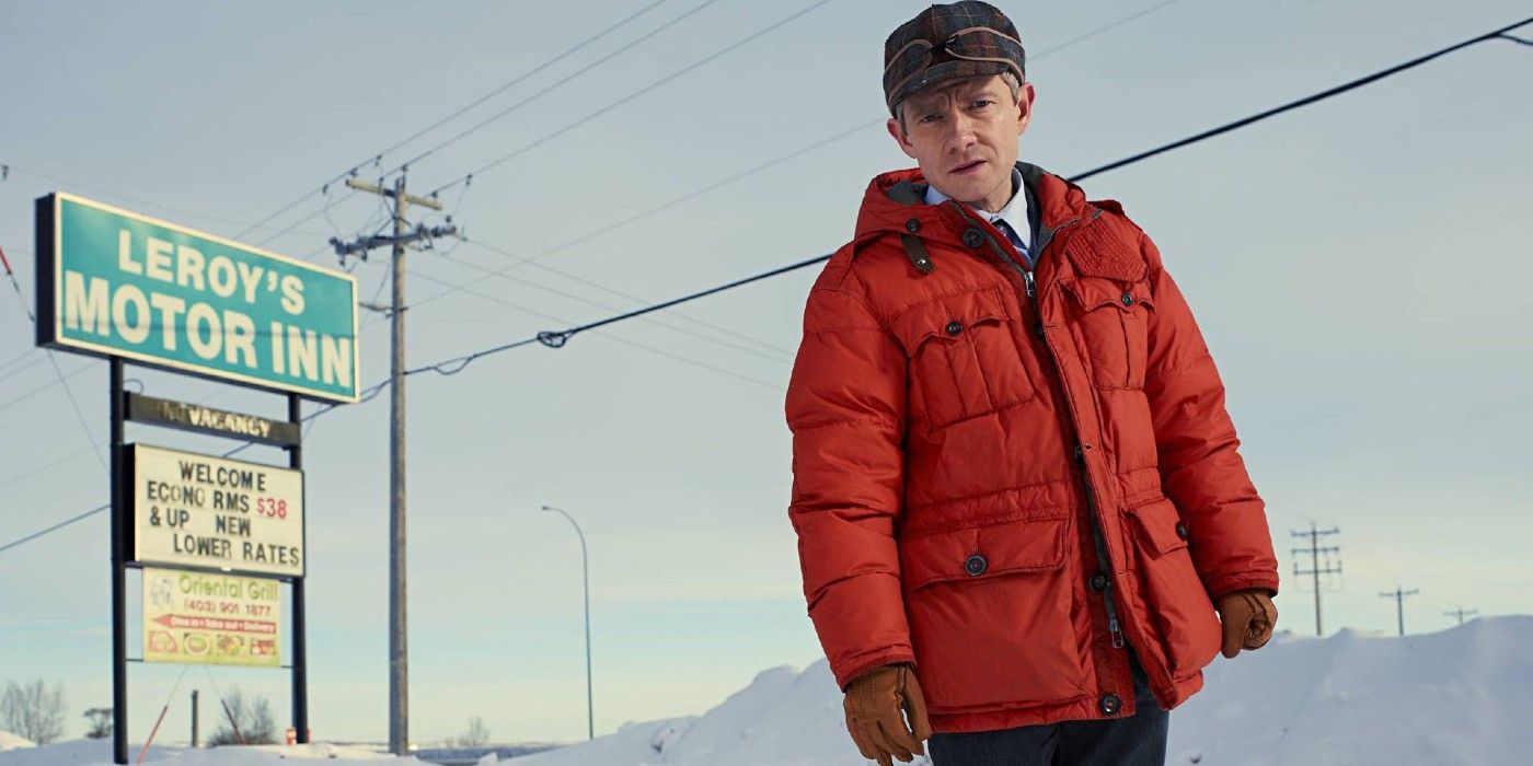 Lester looking down while wearing his orange jumper in Fargo