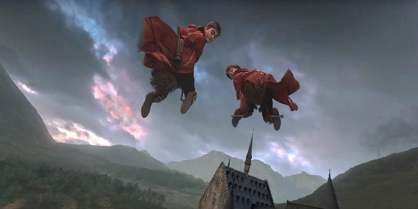Two Gryffindor Quidditch players flying in a stormy grey sky.