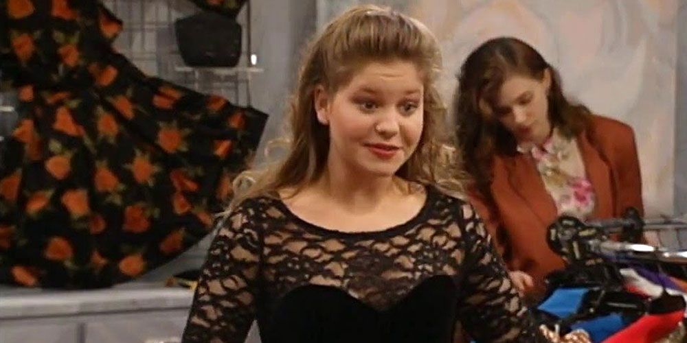 DJ Tanner at clothing store wearing black cocktail dress in Full House