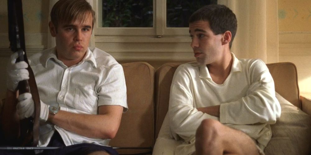 Peter and Paul sitting on the couch in Funny Games (1997)