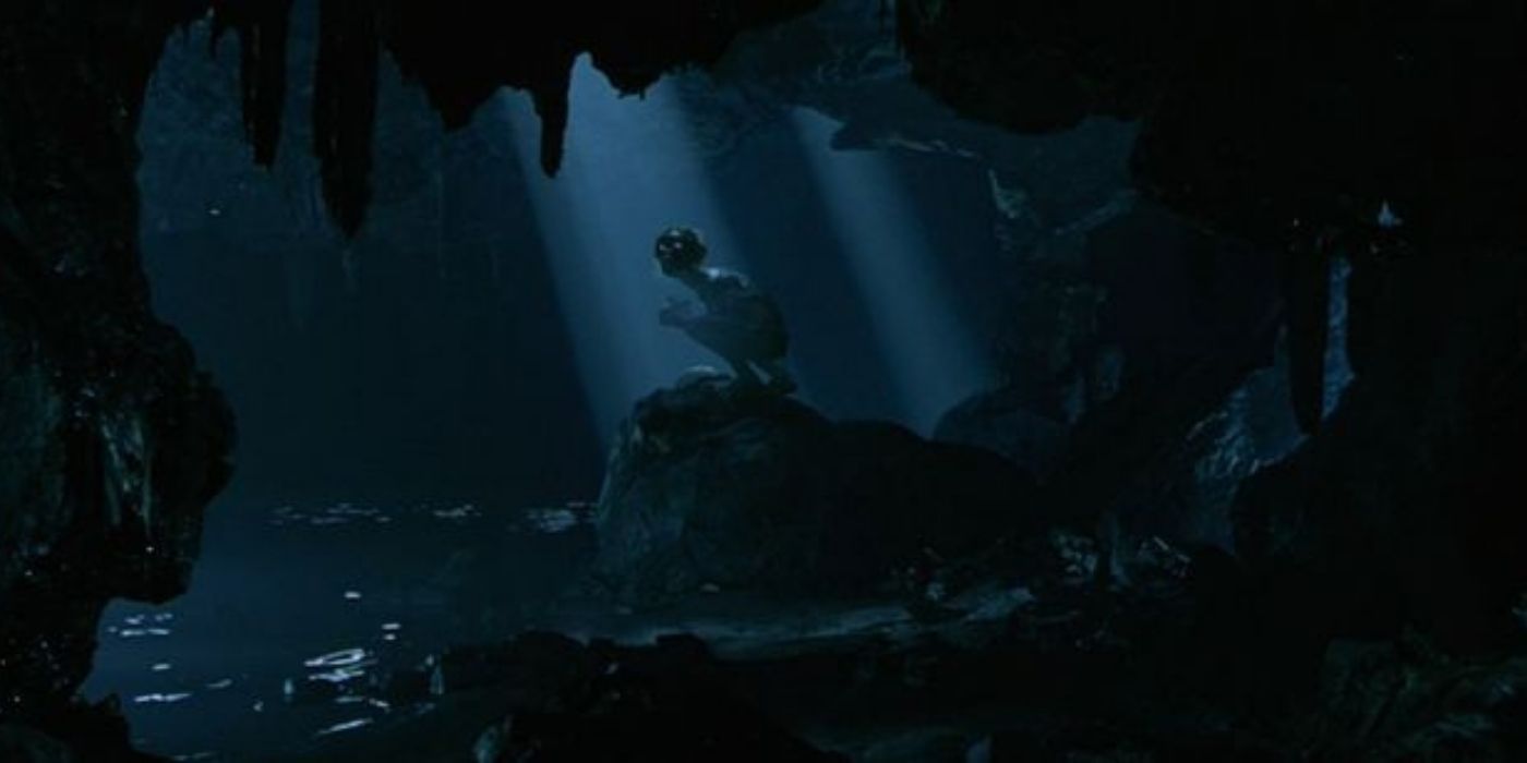 Gollum sitting on a rock in Lord of the Rings the Fellowship of the Ring