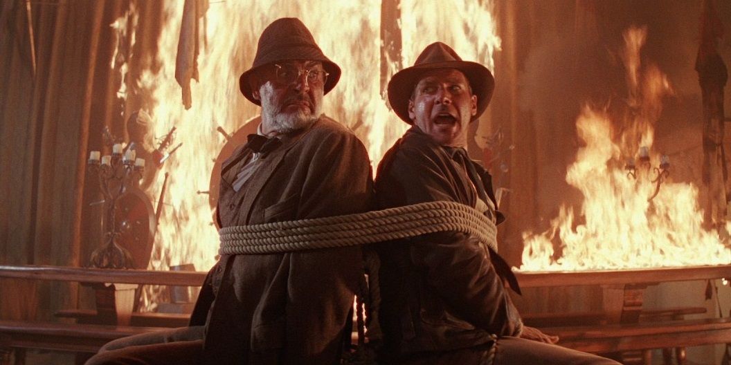 Harrison Ford and Sean Connery tied up in a room on fire in Indiana Jones and the Last Crusade