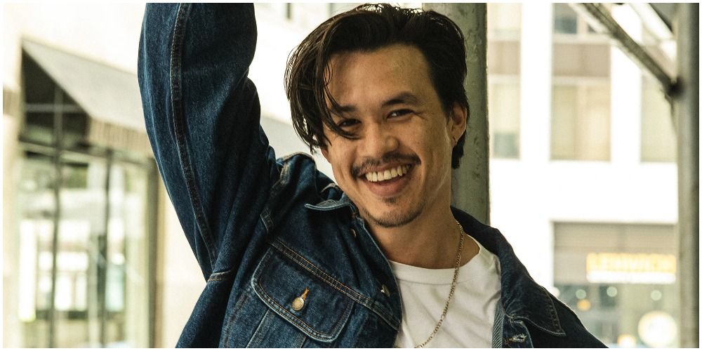 Andrew arm up, jean jacket white tee on Insecure