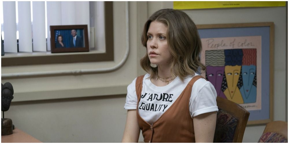 Frieda in white tee with brown jumper in office on Insecure