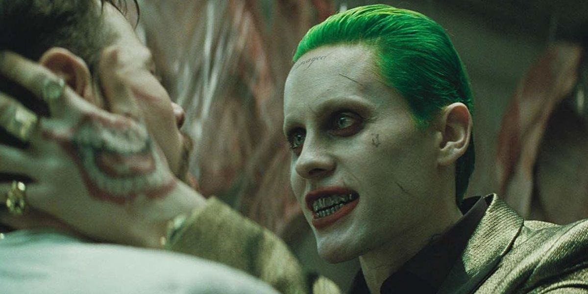 Joker grabs a thug's neck in Suicide Squad