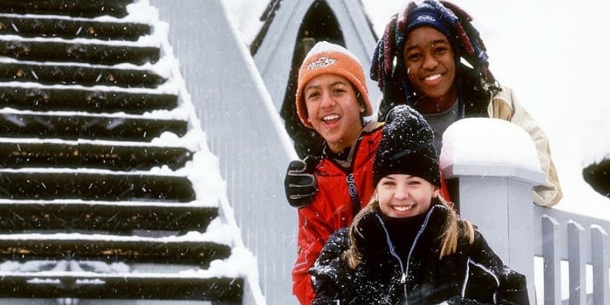 Original cast of Johnny Tsunami smiling in the snow next to some stairs