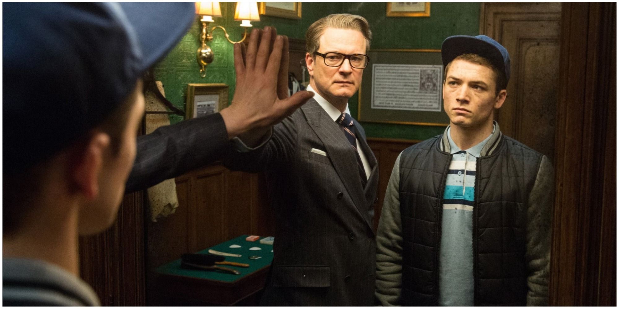 Harry (Colin Firth) and Eggsy (Taron Egerton) inside the Kingsman shop in Kingsman: The Secret Service