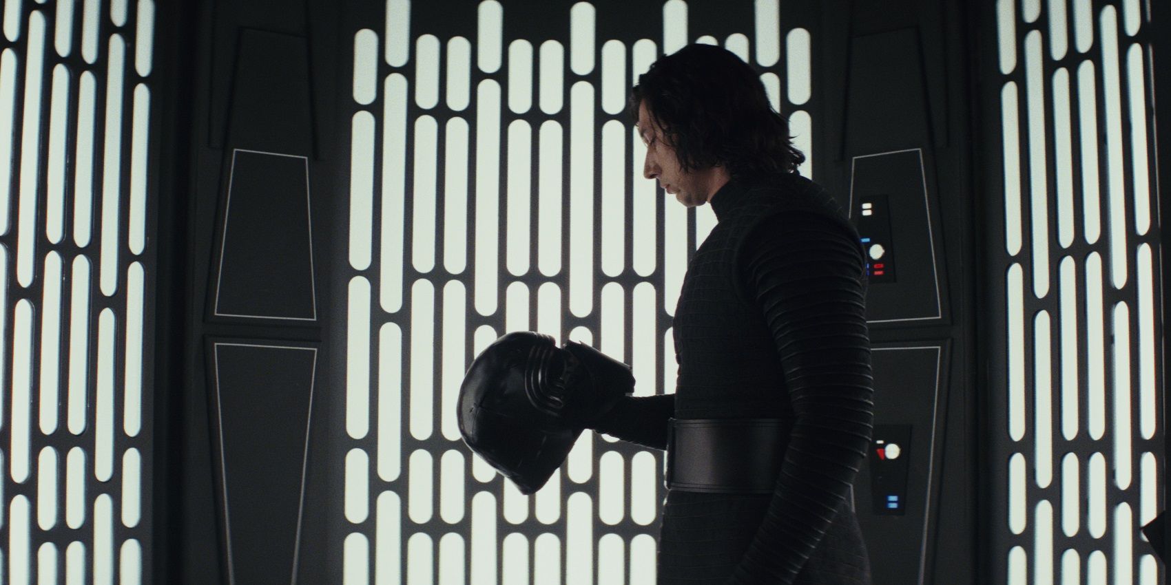Kylo Ren looks at his helmet in Star Wars The Last Jedi