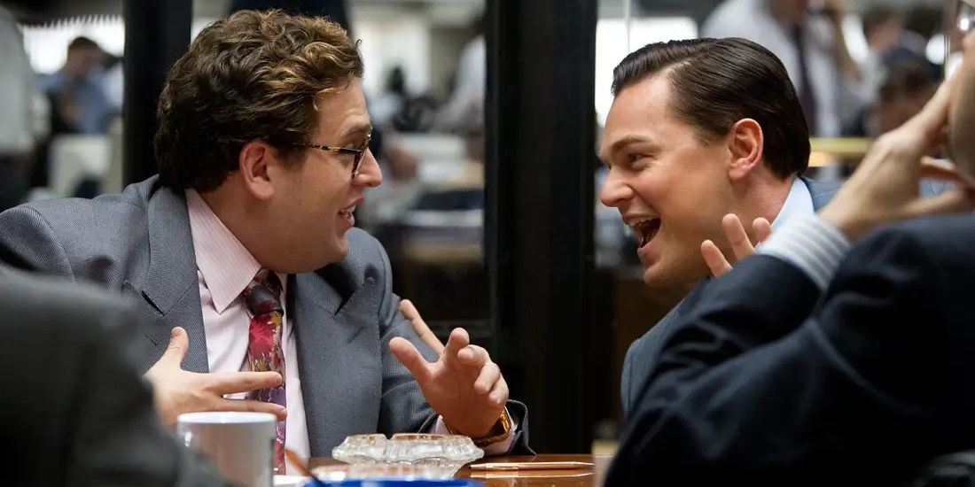 Leonardo DiCaprio and Jonah Hill in a board room in The Wolf of Wall Street
