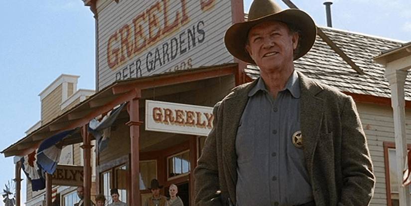 Gene Hackman as Little Bill Daggett standing in the street in Unforgiven