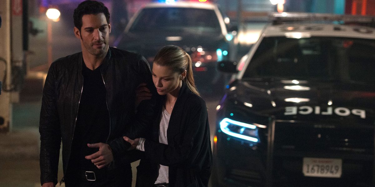 Tom Ellis as Lucifer in season one standing by a police car