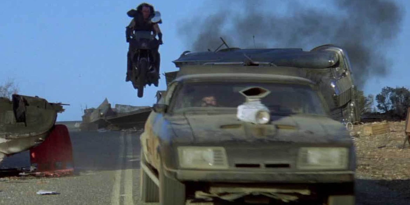 A motorcycle chasing a car in The Road Warrior