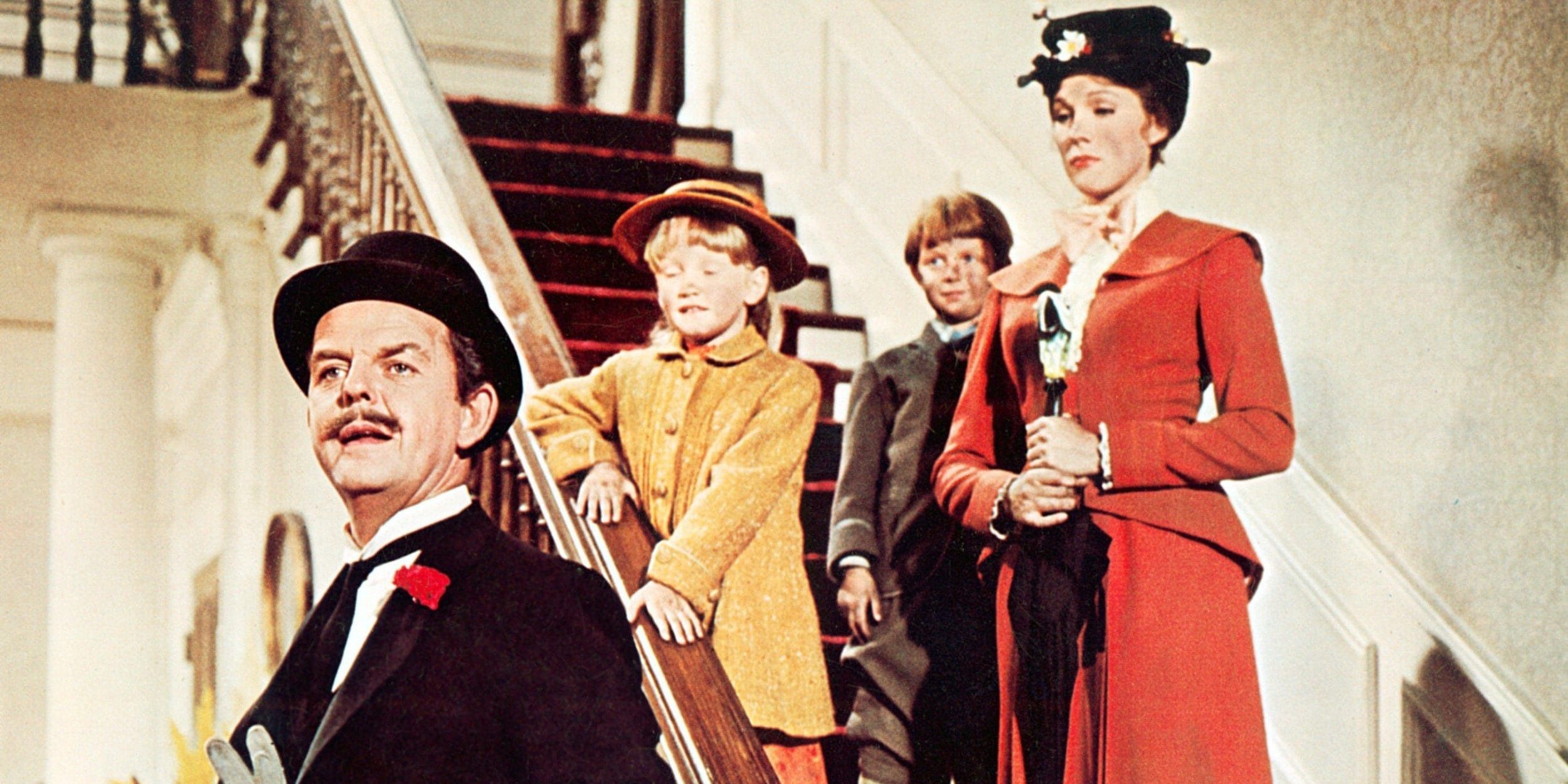 Mary and the Banks children stand on the stairs with Mr. Banks in front of them in Mary Poppins