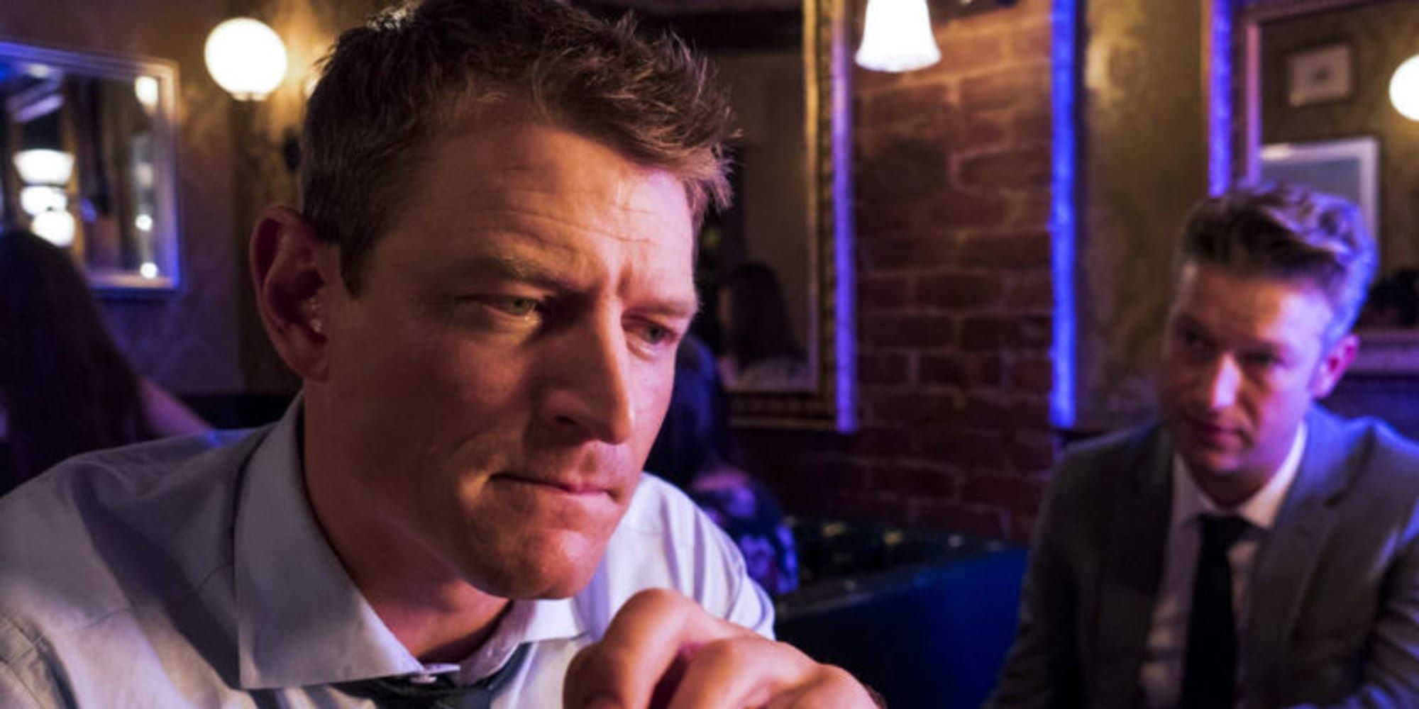 Peter Stone contemplative in a bar