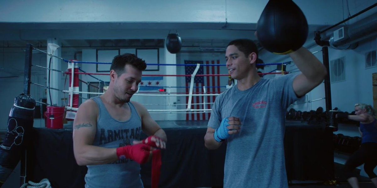 Antonio Dawson putting red tape on his hands in his boxing gym