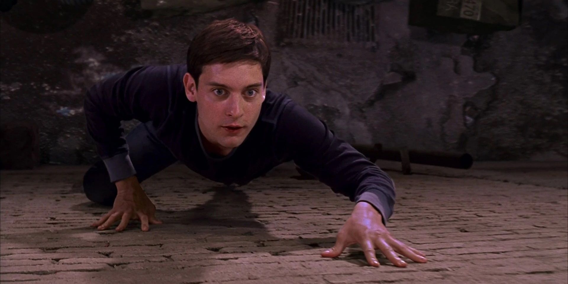 Peter Parker crawls up a wall in Spider-Man