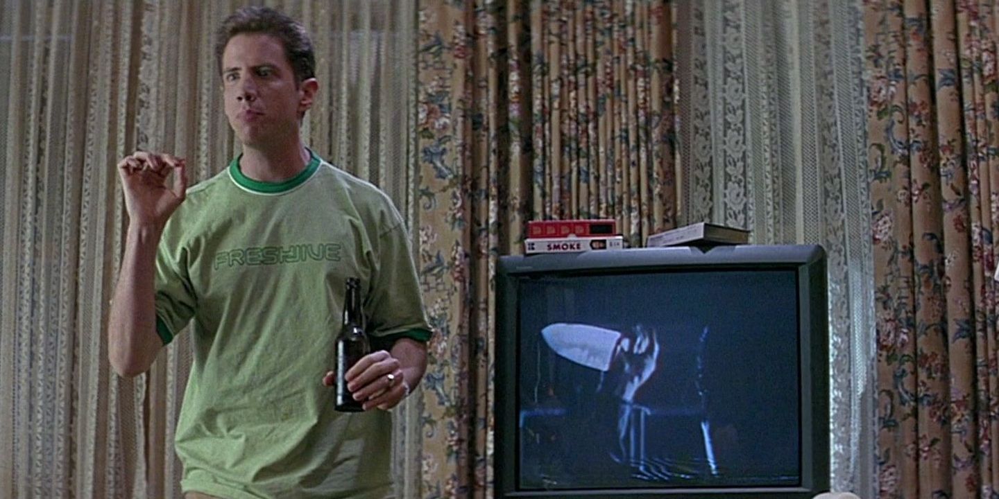 Randy standing beside a TV and talking about horror movie rules in Scream