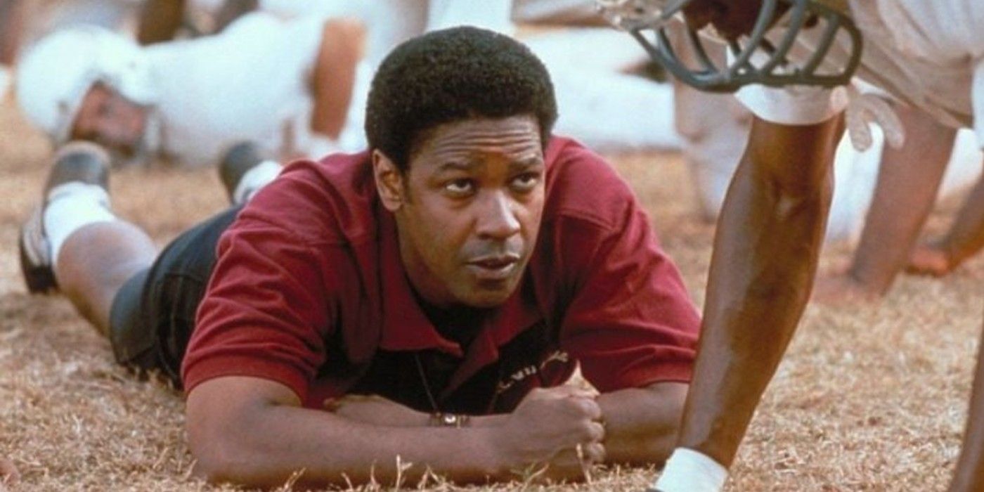 Coach Boone lying on the field with a player in Remember the Titans
