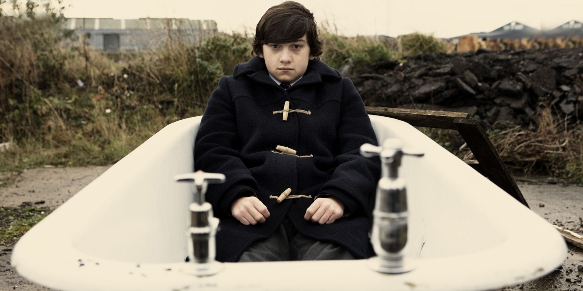 Craig Roberts sitting in a bathtub in a still from Submarine.