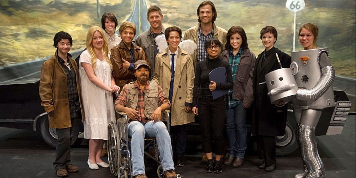 The cast of Fan Fiction pose for a photo in Supernatural