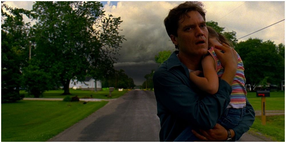 Man Holding Little Girl With Storm Behind Him