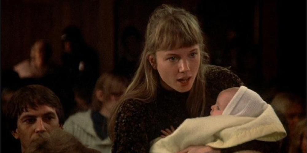 Carol holding a baby in Testament (1983)