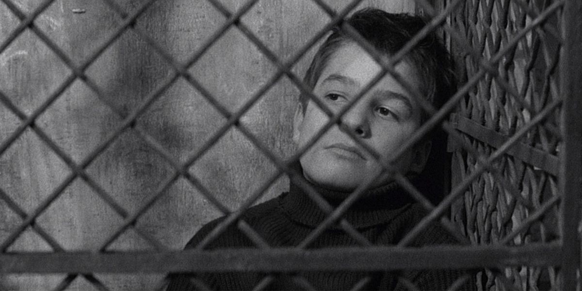 A young boy locked up behind bars