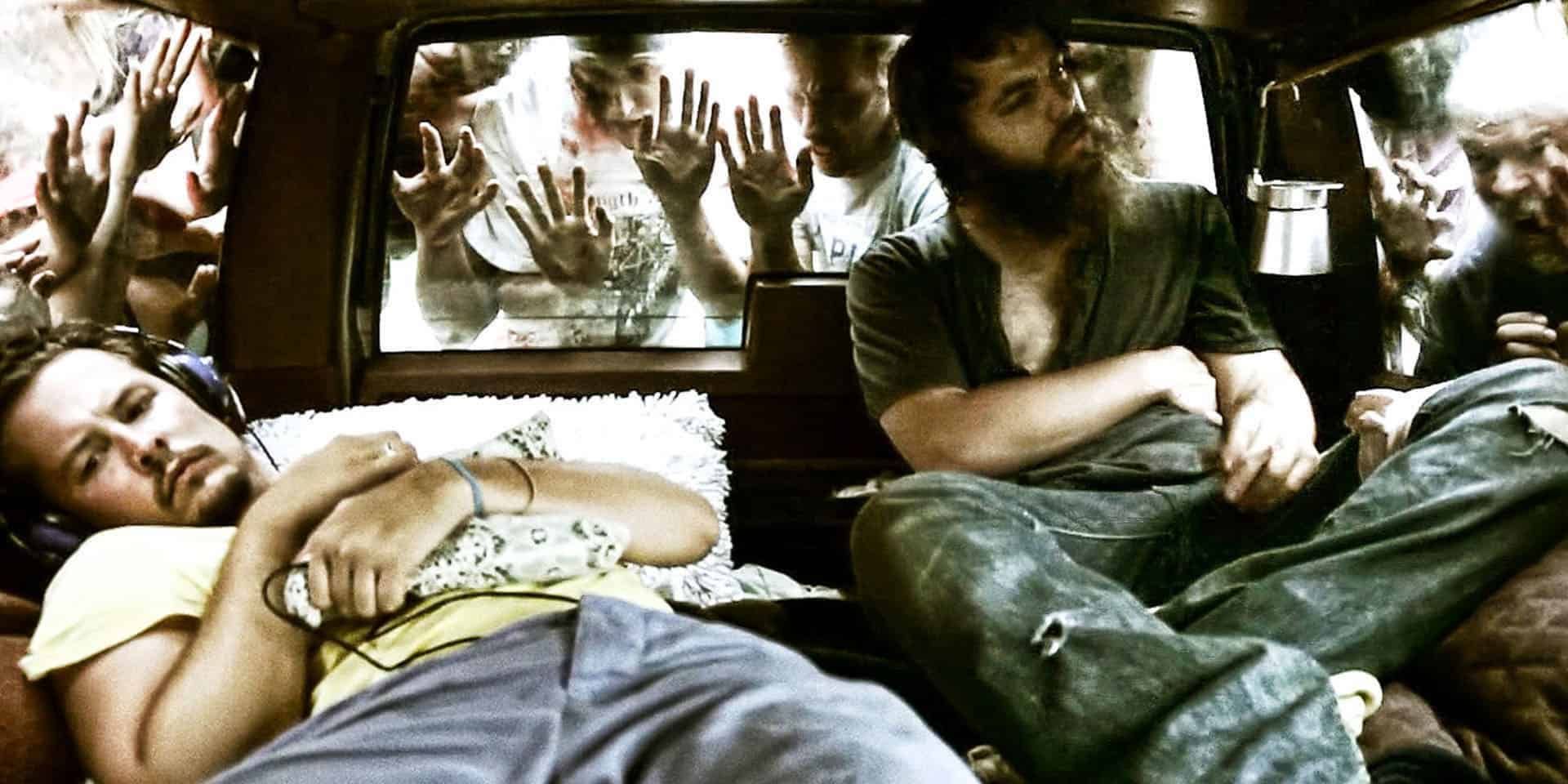 Ben and Mickey sitting in the car surrounded by zombies in The Battery 2012