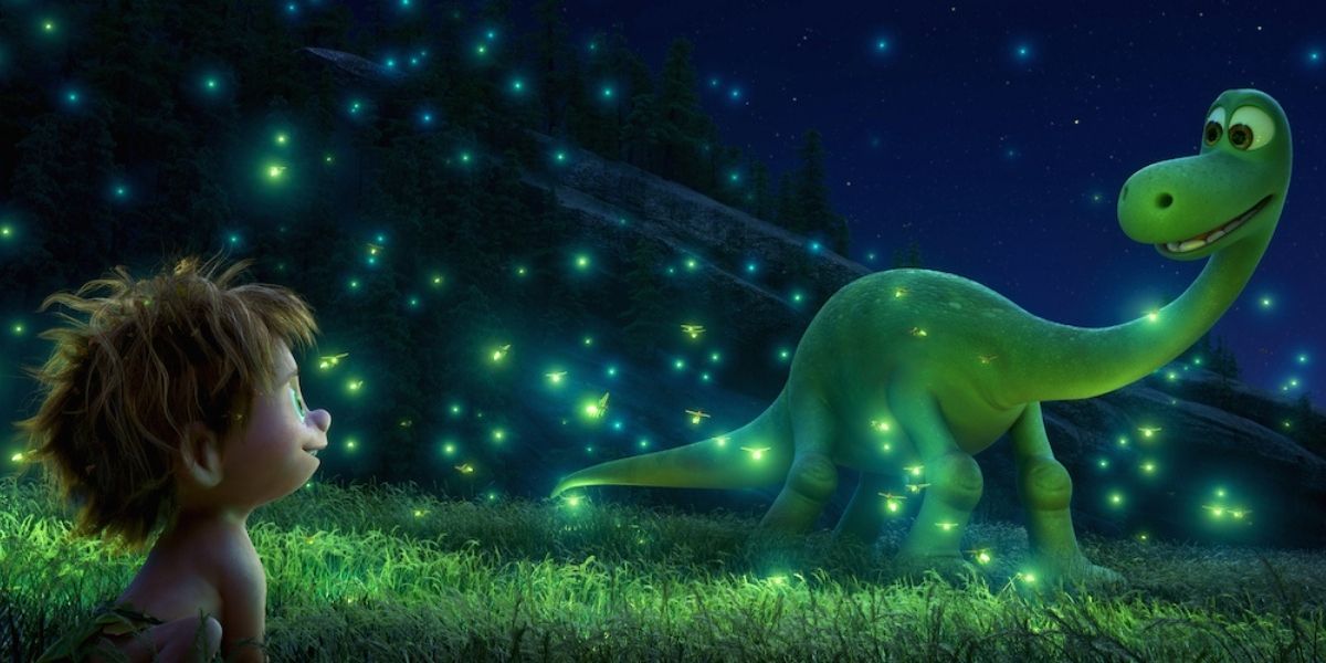 Arlo and Spot play with fireflies in The Good Dinosaur