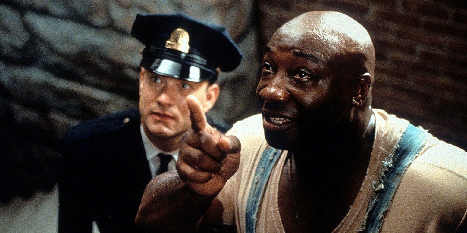 John Coffey points at something and Paul looks on in The Green Mile.