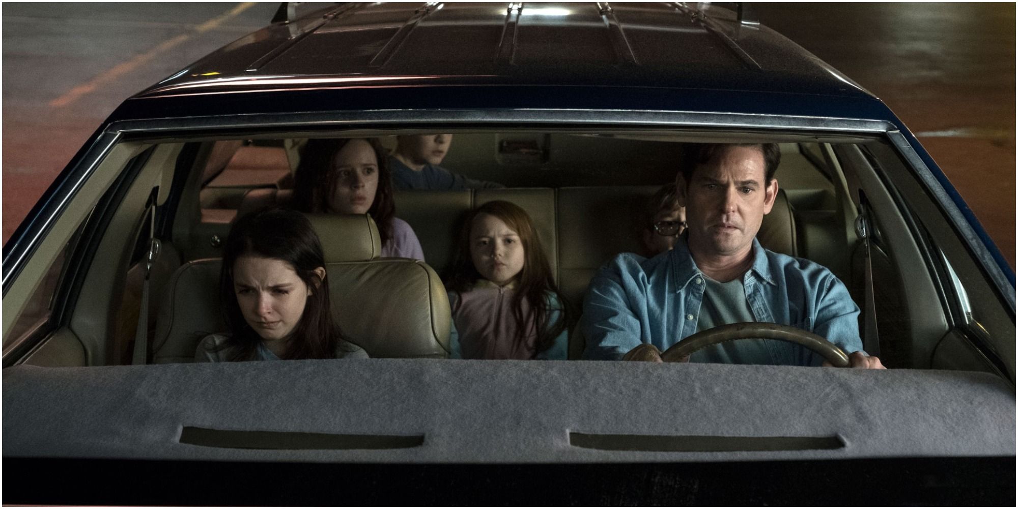A still shot of the Crain children and their father Hugh in The Haunting of Hill House