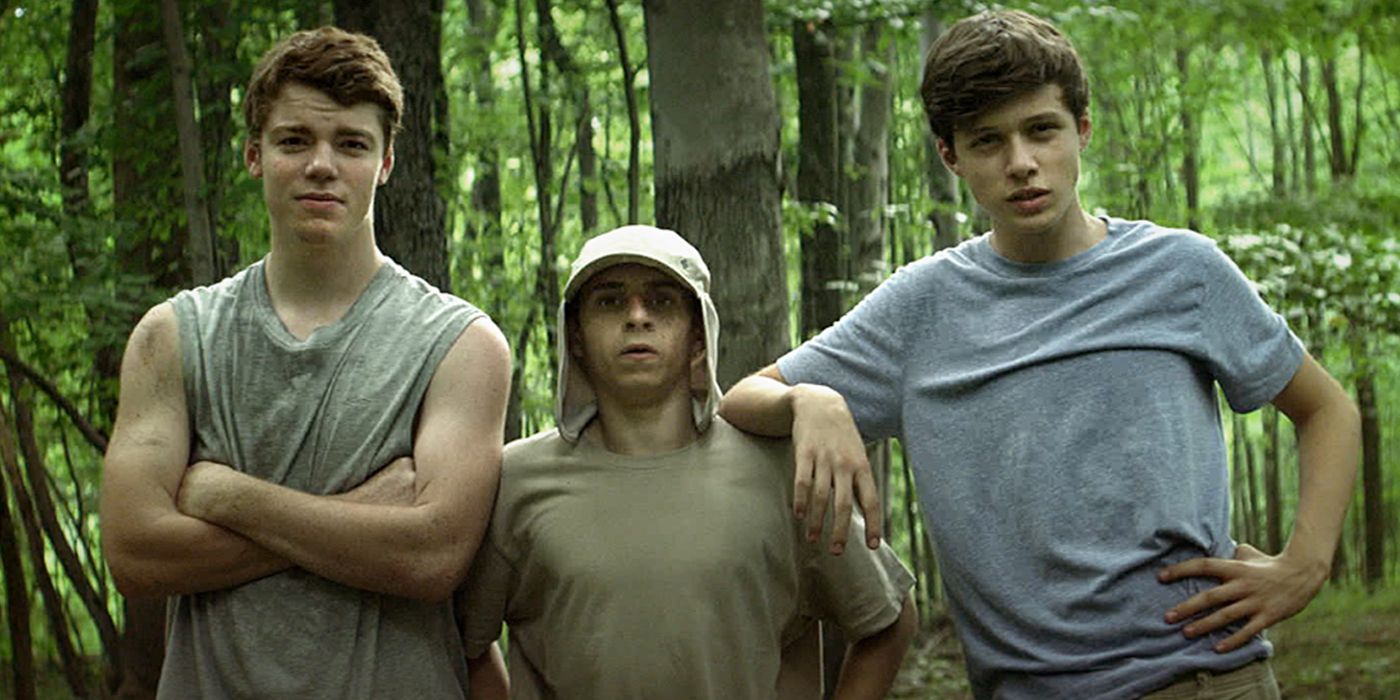 Patrick, Biaggio, and Joe posing next to each other in the woods in The Kings of Summer