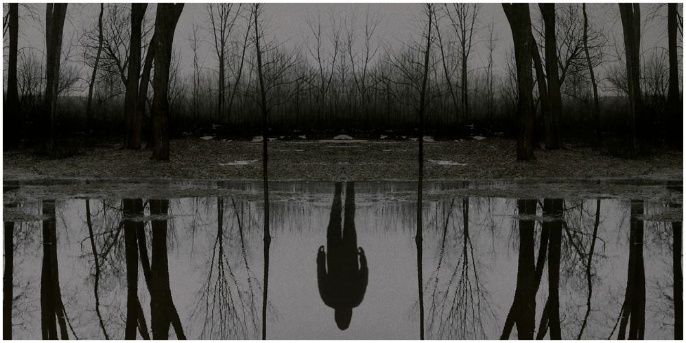 Reflection Of Man In Lake