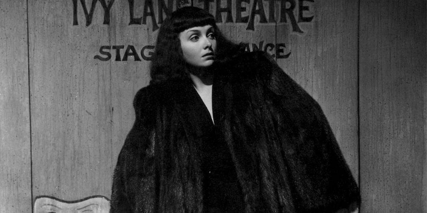 Frightened women walking with a big fur coat in The Seventh Victim