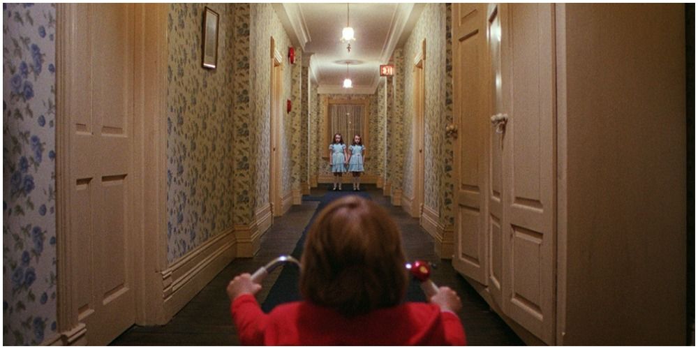 Boy Riding Trike Down A Hall