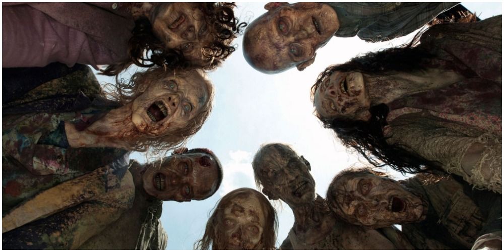 A circle of Walkers staring down at the camera in The Walking Dead