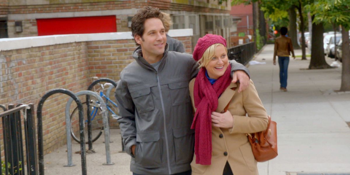 Joel and Molly smile and walk down the street in They Came Together