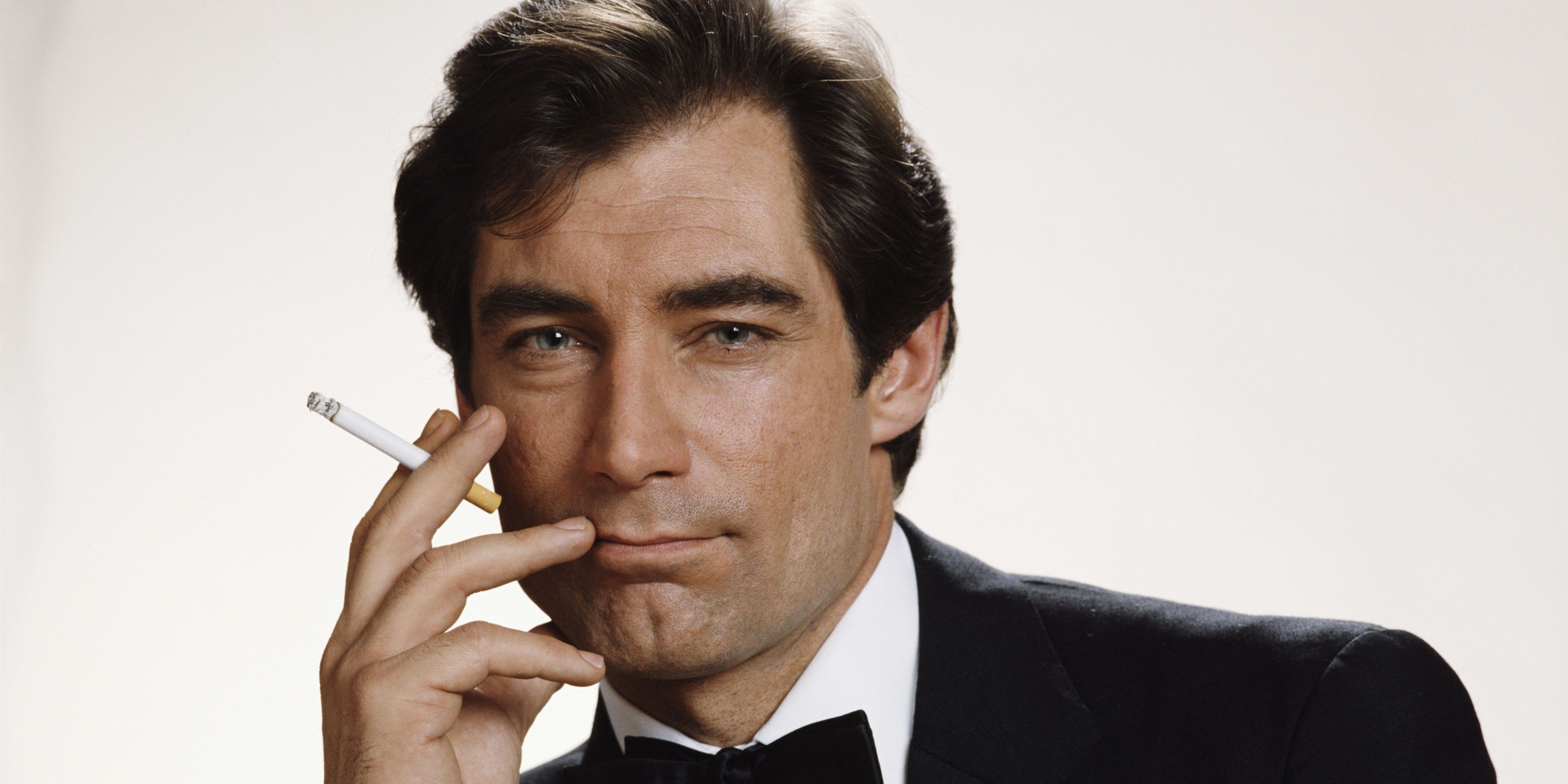 Timothy Dalton as James Bond smoking a cigarette