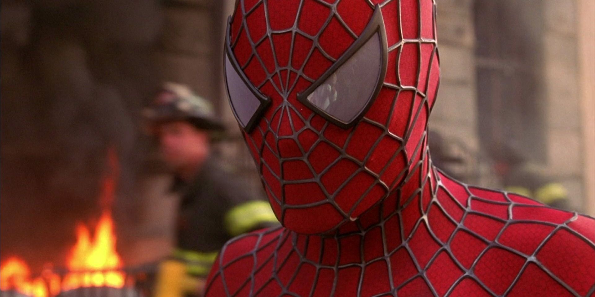 Tobey Maguire as Spider-Man at an apartment building on fire