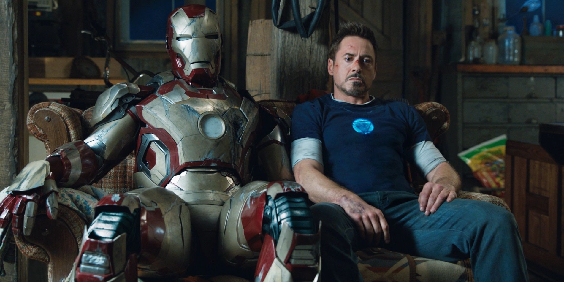 Tony Stark sits next to his suit in Iron Man 3