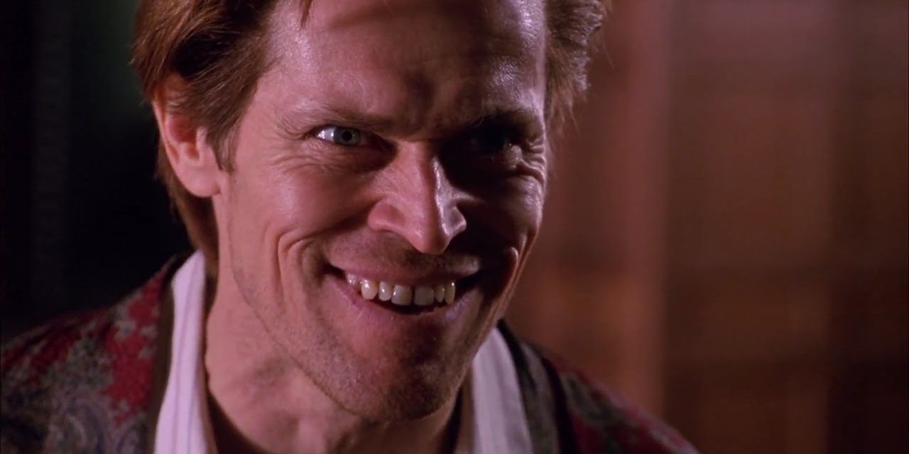 Norman Osborn with a creepy smile in Spider-Man, grinning evilly