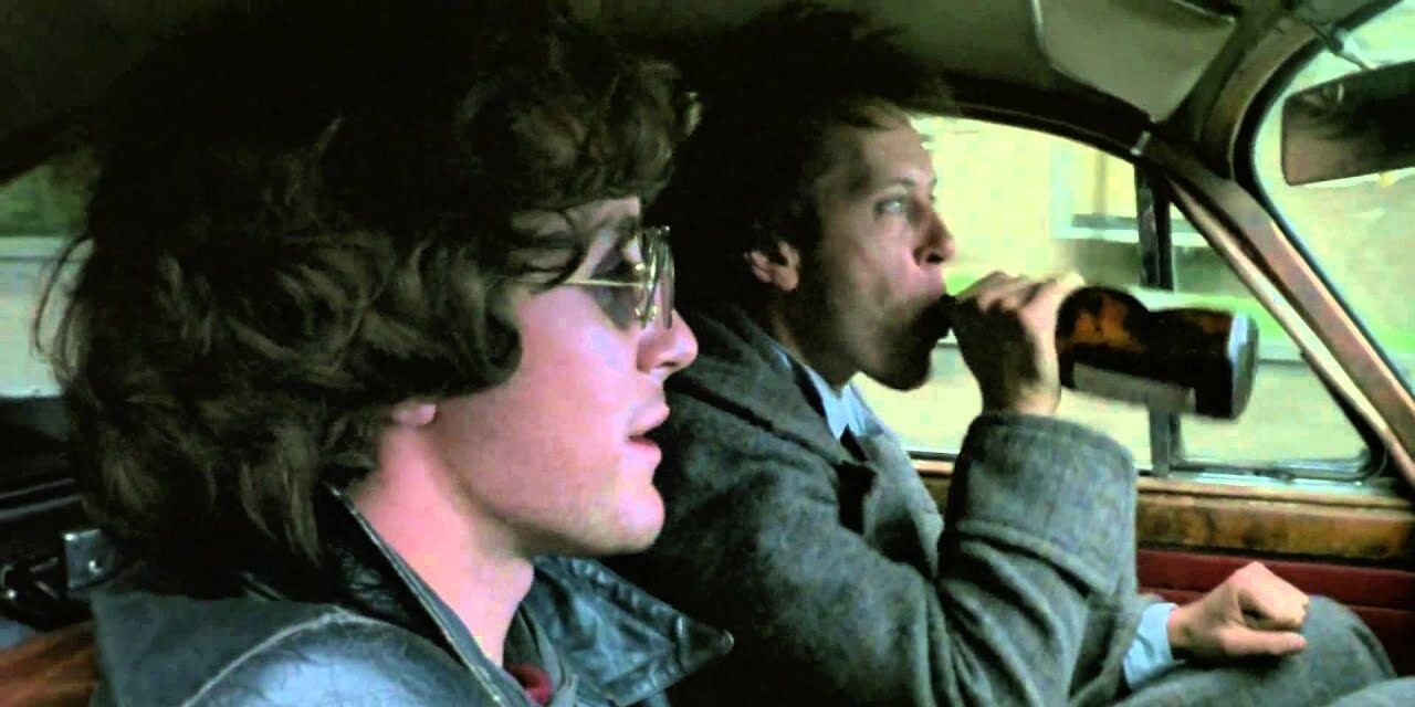 Withnail drinks beer in a a car in Withnail &amp; I