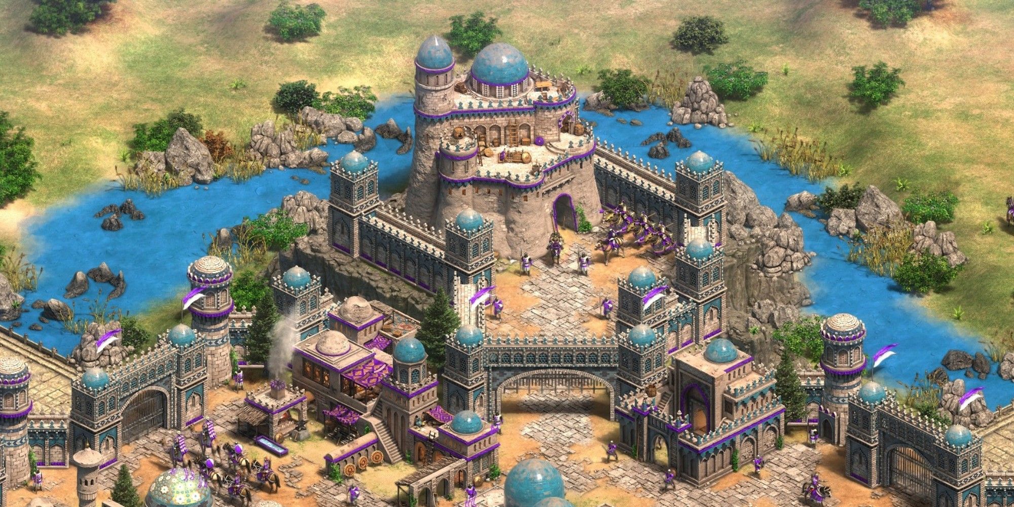 A large city looms over a river in Age of Empire IV