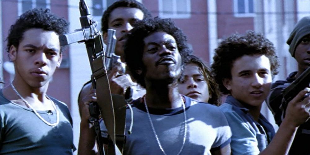 Knockout Ned holds a machine gun in City of God