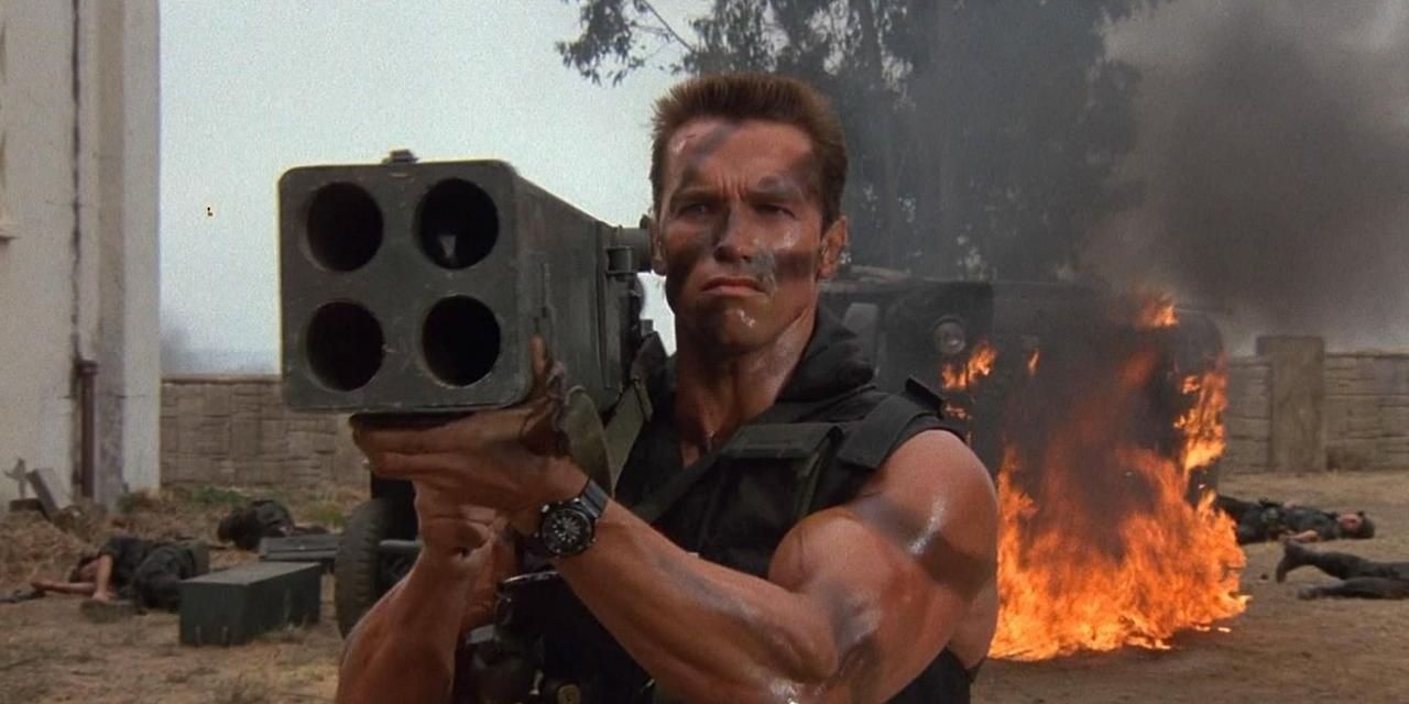 A bruised John Matrix supporting a large gun on his shoulder
