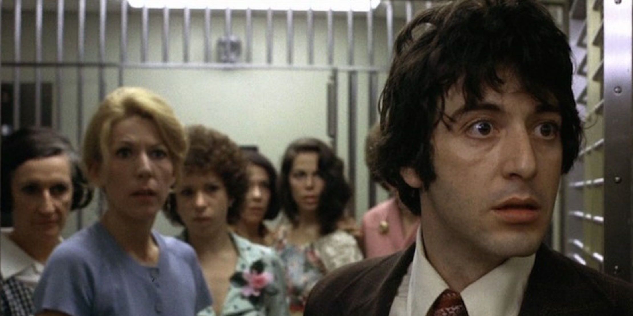 Al Pacino in the precinct with people behind him.