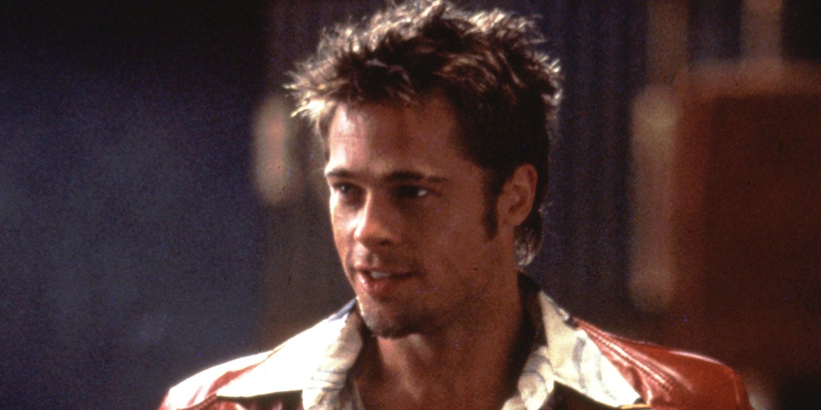 Uma foto de Brad Pitt como Tyler Durden em um terno vermelho. 